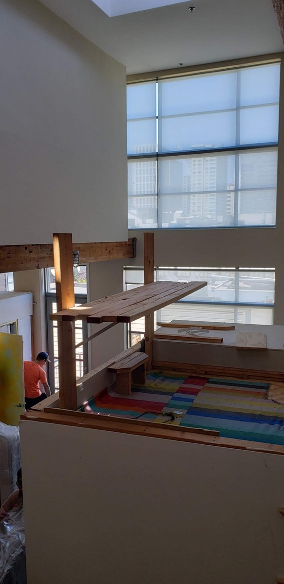View from above: painted roof deck on the cube with a lumber desk being framed on top